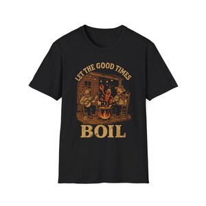 May include: Black t-shirt with a vintage illustration of three people playing music on a porch with a pot of boiling water. The text "Let the good times boil" is printed on the shirt.