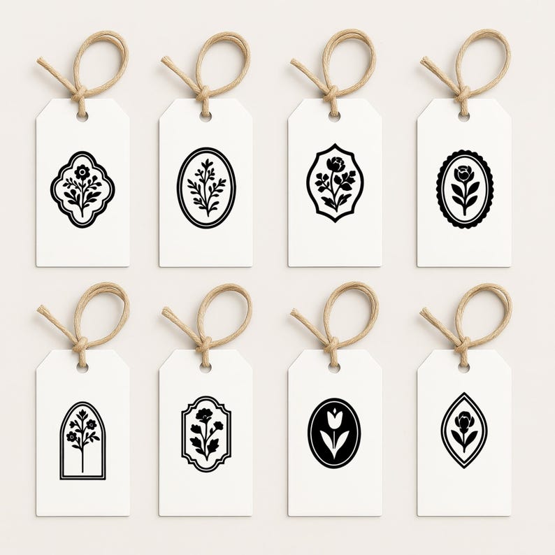 May include: Eight white gift tags with black floral designs. Each tag has a different floral motif, including a tulip, a single flower, and a bouquet of flowers. The tags are tied with twine.