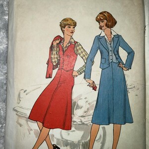 May include: Vintage Simplicity sewing pattern featuring illustrations of two women in stylish outfits. One woman wears a red dress with a plaid shirt, and the other a blue pinstripe suit. The pattern is size 10, Miss.