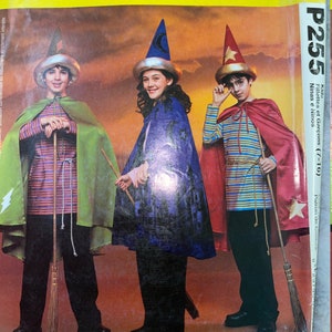 May include: McCall's Costumes pattern P255 featuring children dressed as wizards. The costumes include capes, hats, and striped shirts. The image shows three children holding brooms, ready for Halloween or a costume party.