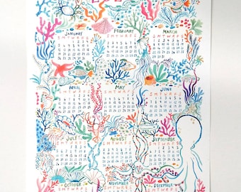 May include: A watercolour illustration of a 2020 calendar with a nautical theme. The calendar features a variety of sea creatures, including fish, crabs, and coral. The background is a light blue colour with white accents.