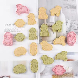 May include: A set of 15 cookie cutters shaped like sheep in various colors, including pink, yellow, and green. The cutters are made of plastic and have a smooth, polished finish.