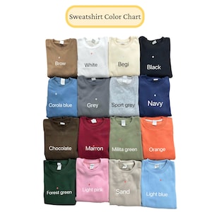 May include: A color chart displaying various sweatshirt colors. The chart includes colors such as brown, white, beige, black, corola blue, grey, sport grey, navy, chocolate, maroon, military green, orange, forest green, light pink, sand, and light blue.