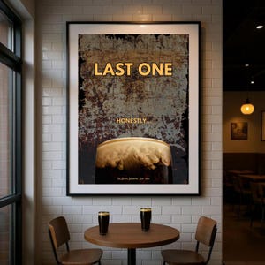 Framed dark humour wall art print reading Last One displayed in a cosy pub style interior with warm lighting and vintage textures, stout beer inspired artwork ideal for home bar decor, pub wall art, kitchen wall decor, man cave interiors and gifts for beer lovers who appreciate bold typography and understated humour