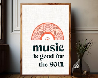 May include: A framed print with a wooden frame. The artwork features a retro orange vinyl record design above the words "music is good for the SOUL" in teal. The background is off-white.