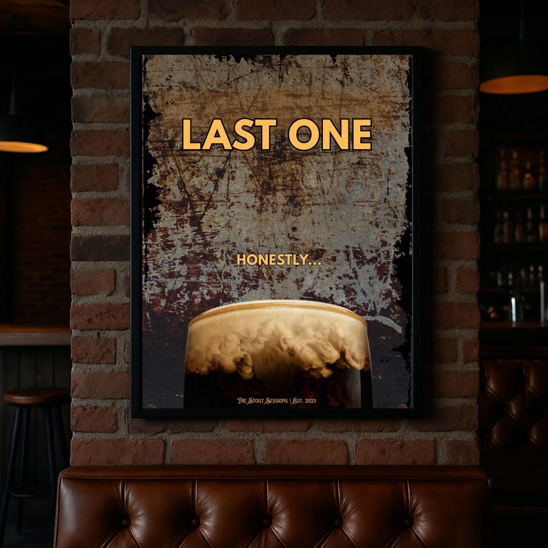 Last One framed poster displayed against an exposed brick wall in a pub inspired interior, featuring distressed vintage textures and stout beer imagery, perfect for bar wall decor, pub rooms, rustic interiors and dark humour wall art collections