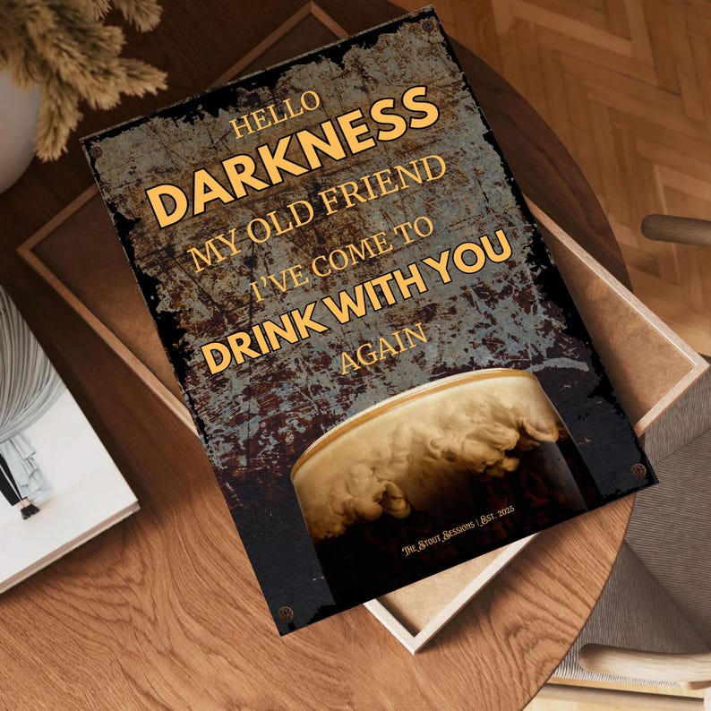 Angled overhead view of the “Hello Darkness” Guinness-inspired art print resting on a wooden desk with scattered décor items, emphasising high-quality matte finish and modern typography, perfect for home pub décor.