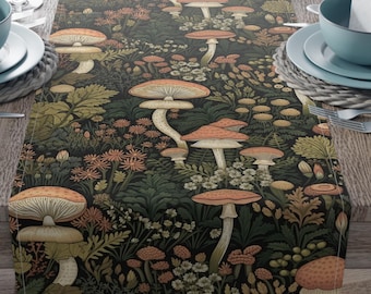 May include: A table runner with a dark background featuring a whimsical mushroom pattern in shades of orange, beige, and green. The runner is set on a wooden table with place settings, wine glasses, and a vase of pink lilies.
