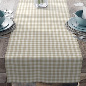 May include: A beige and white gingham table runner adorns a wooden table, ready for a meal. The table is set with blue bowls, white plates, cutlery, and wine glasses. A vase of pink flowers sits in the centre.