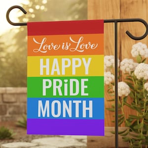 May include: A rainbow-colored garden flag with the text "Love is Love Happy Pride Month".