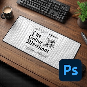 May include: A rectangular mousepad with the text "The Gothic Merchant" in a gothic font, surrounded by floral and leaf designs. The background has a repeating pattern of the words "Your Design". A black keyboard and a coffee mug are visible.