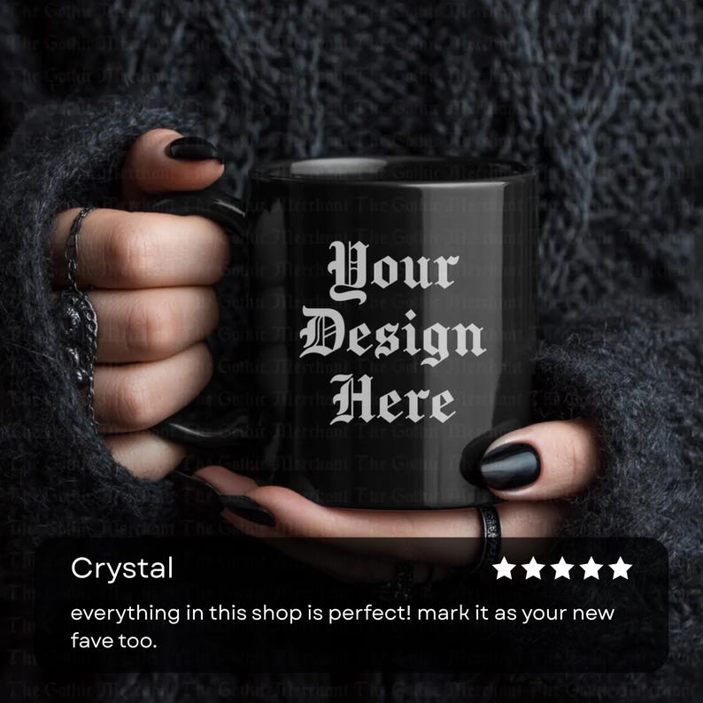 May include: Black ceramic mug with the text "Your Design Here" in white gothic font. The mug is held by a person with black nail polish and rings. The mug is a standard size for coffee or tea.
