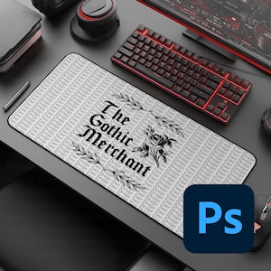 May include: A black and white mousepad with the text "The Gothic Merchant" and a floral design. A red-lit keyboard and a black mouse are also visible. The Adobe Photoshop logo is in the bottom right corner.