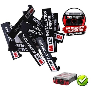 May include: A collection of black plastic labels for Milwaukee M12 and M18 tool organisers. Each label features white text identifying specific tools like Installation Driver, Rotary Tool, and Batteries. Includes a small image of a Packout box.