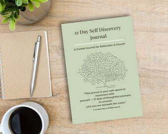 May include: A light green journal titled "21 Day Self Discovery Journal" with a tree illustration. The journal is on a wooden surface next to a cup of coffee, a pen, and a notepad. The journal's text reads "A Guided Journal for Reflection & Growth."