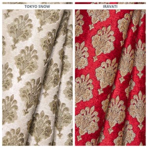 May include: Two fabric swatches with a gold and brown floral pattern. The fabric on the left is a light beige color, and the fabric on the right is a deep red color. The fabric swatches are labeled "Tokyo Snow" and "Iravati".