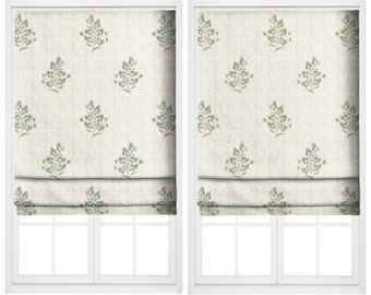 May include: Two window treatments, each with a floral pattern in shades of green and beige. The text "NIGHT BLOOMING" and "HARWOOD PUTTY" are above each window treatment. The window treatments are in a white frame.