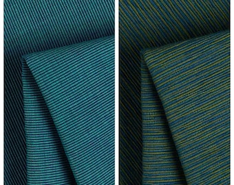 May include: Two fabric samples, one teal and the other a mix of teal and olive green. The teal fabric is labeled "Savory Sea" and the other is labeled "Dione". Both fabrics have a ribbed texture.