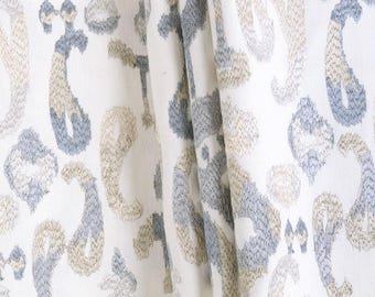 Könnte beinhalten: Weißer Stoff mit einem sich wiederholenden Paisley-Muster in Grau- und Beigetönen. Das Wort "WHIRLWIND" ist oben aufgedruckt. Geeignet für Heimtextilien und andere Textilprojekte.