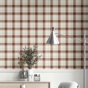 May include: A wall with a brown and cream plaid pattern. The wall is decorated with a white trim and a wooden cabinet with decorative items, including vases and a glass jar. A silver lamp is positioned to the right.