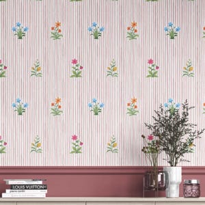 May include: Wallpaper with a repeating pattern of colorful floral bouquets in blue, orange, pink, and yellow, set against a white background with vertical red stripes. The design is reminiscent of a vintage botanical print.