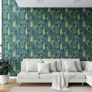 May include: A teal wallpaper with a repeating pattern of green and red trees and foliage. A white sectional sofa with white pillows and a white blanket is in front of the wallpaper. A potted plant is on the left.