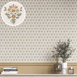 May include: Cream-colored wallpaper with a repeating floral pattern in muted yellow, green, and brown. A close-up shows a detailed floral illustration. The wallpaper is installed above a neutral-toned baseboard and shelf, with decorative items.