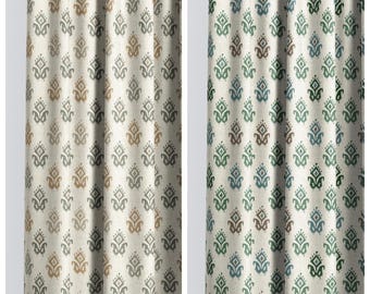 May include: Two panels of fabric curtains featuring a repeating damask-style pattern. The left panel, labeled RIJEKA, has tan and gray motifs on a cream background. The right panel, labeled SHINING ARROW, has green and blue motifs on a cream background.