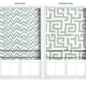 May include: Two window treatments with white frames. The left one is labeled "SEA GLASS" and features a zigzag pattern in seafoam green and white. The right one, labeled "OCEANIC TEAL," has a maze-like design in the same colors.