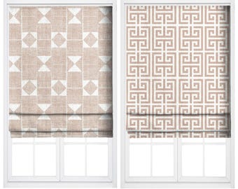 May include: Two window treatments are displayed. The left one is labeled "LIGHT CHIFFON" and features a geometric pattern in white and beige. The right one, labeled "BLANCHED CORAL", has a repeating Greek key design in beige and white.