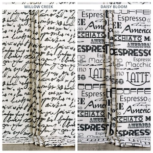 May include: Two decorative curtain panels. The left panel features black script on an off-white background, labelled "Willow Creek." The right panel, "Daisy Bloom," has coffee-themed text and graphics in black on white.