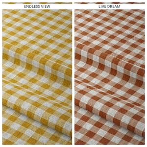 May include: Two fabric samples, one in a yellow and white checkered pattern, the other in a brown and white checkered pattern. The fabric is folded, showing the texture and weave of the material. The text "ENDLESS VIEW" and "LIVE DREAM" are at the top.