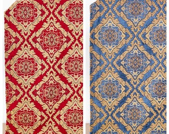 May include: Two fabric swatches with a damask pattern. The swatch on the left is red with gold accents. The swatch on the right is blue with gold accents. The text "Shy Regal" is above the left swatch and the text "Kara Sea" is above the right swatch.