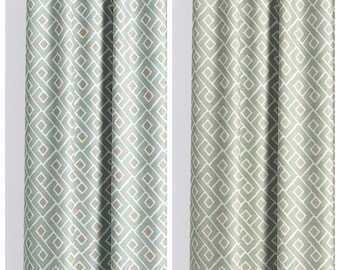 May include: Two fabric curtains featuring a geometric pattern of white interlocking lines and beige squares. The left curtain is labeled NATURE WHISPER in a light blue-green tone, while the right curtain is labeled CALM ABSINTHE in a muted olive green.