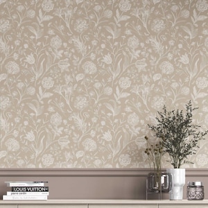May include: Beige wallpaper with a repeating white floral pattern. The design features various flowers and foliage, creating a classic and elegant look. The wallpaper is suitable for interior decoration and adds a touch of sophistication to any room.