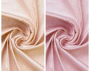 May include: Two fabric swatches, one in a light peach color labeled "MEADOW LARK" and the other in a pink hue labeled "MIX CANDY". The fabric is gathered and folded, showing a lustrous sheen.