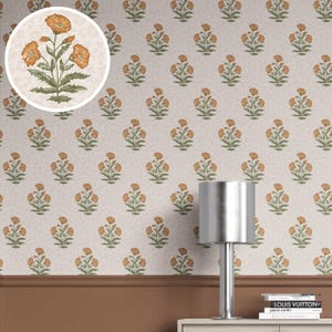 May include: Wallpaper with a repeating pattern of orange flowers and green leaves on a cream backdrop. A close-up shows the flower design. A silver lamp and books are in the foreground.