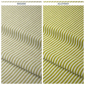 May include: Two fabric samples with a striped pattern. The sample on the left is labeled "MASAMI" and features olive green and white stripes. The sample on the right, labeled "ALLEYWAY", has a similar pattern with a brighter green hue.
