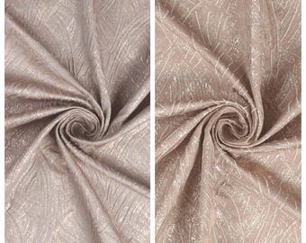 May include: Two swatches of fabric, one labeled "BEAUTY BEACH" and the other "SUGAR CRUSH." Both fabrics are a light, neutral color with a subtle, textured pattern. The fabric is gathered and swirled, showcasing its drape and texture.