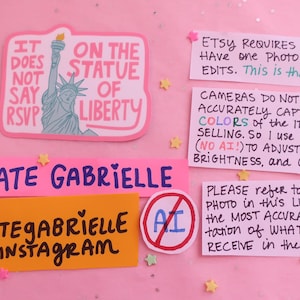 May include: A pink sticker featuring the Statue of Liberty and the text IT DOES NOT SAY RSVP ON THE STATUE OF LIBERTY, alongside several informational notes about Etsy photography policies, Kate Gabrielle branding, and an AI-prohibited symbol.