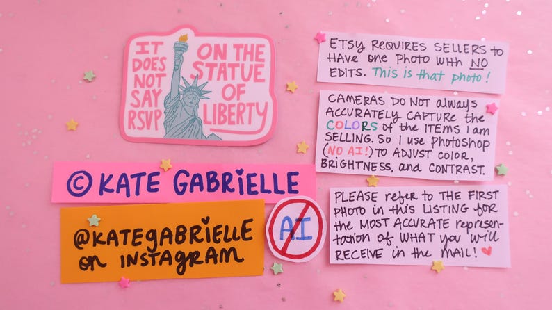 May include: A pink sticker featuring the Statue of Liberty and the text IT DOES NOT SAY RSVP ON THE STATUE OF LIBERTY, alongside several informational notes about Etsy photography policies, Kate Gabrielle branding, and an AI-prohibited symbol.