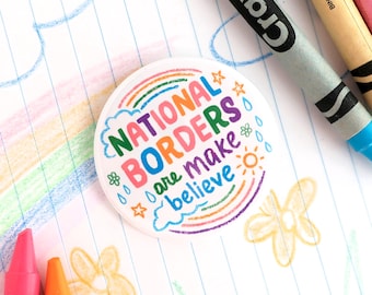 National borders are make believe / pro immigration button pin