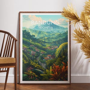 May include: A framed art print showcasing a landscape of Bandung, Indonesia. The image presents green hills, buildings, and a road, set against a blue sky. The words "BANDUNG INDONESIA" are printed at the top of the artwork.