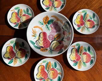 May include: A set of six white ceramic plates with a hand-painted design of pears, apples, and grapes. The plates are in various sizes and are perfect for serving fruit or snacks.