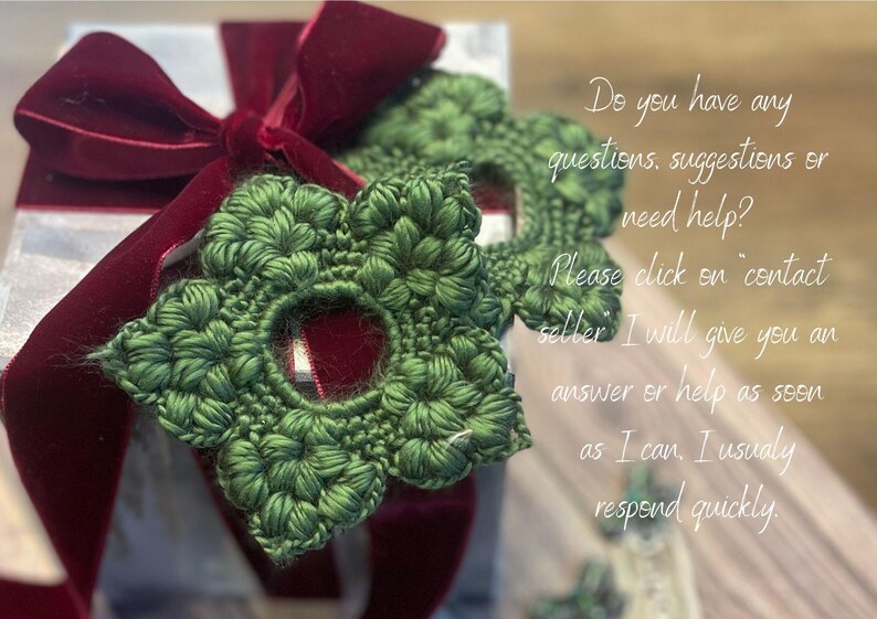 May include: A gift box with a silver and white wrapping, adorned with a deep red velvet bow. Two green, crocheted star-shaped ornaments are placed on top. The image includes text asking for questions.