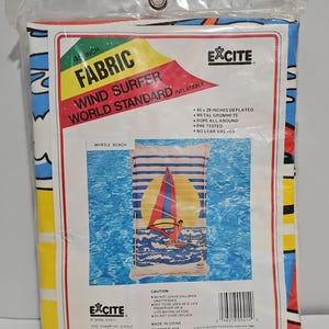 May include: An Excite brand 45-inch inflatable wind surfer fabric in original plastic packaging. The packaging features the text 'WIND SURFER WORLD STANDARD', '45 X 29 INCHES DEFLATED', and an illustration of a person windsurfing on blue water.