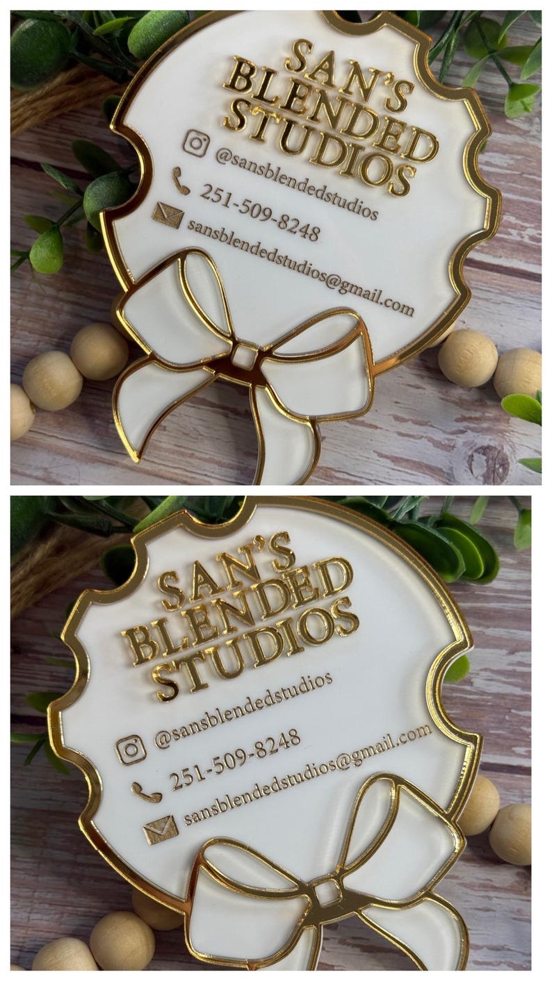 May include: A white and gold business card with the text "SAN'S BLENDED STUDIOS". The card has a gold border and a bow design. Contact information includes an Instagram handle, phone number, and email address.
