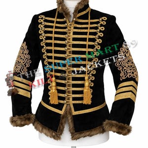 May include: Black military-style jacket with gold trim, decorative tassels, and faux fur collar and cuffs. The jacket features intricate gold embroidery on the sleeves and front, and is displayed on a white mannequin.