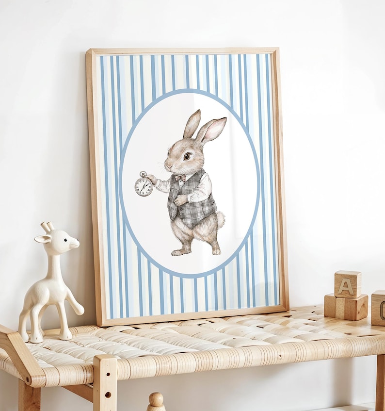 May include: A framed print of a cartoon rabbit wearing a vest and holding a pocket watch. The rabbit is standing in a circle on a blue and white striped background.