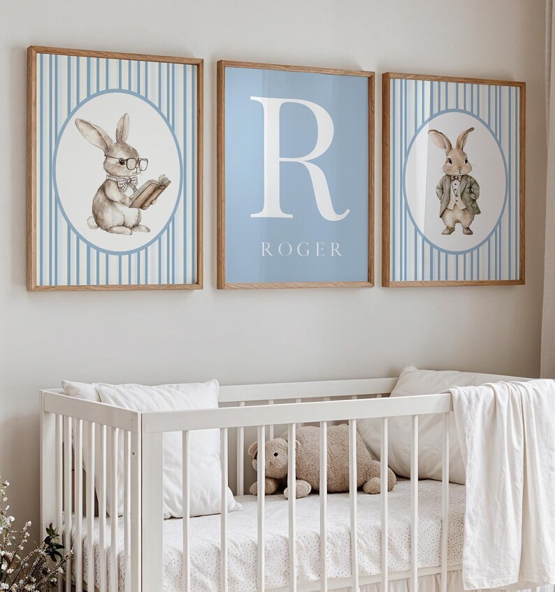 May include: Three framed prints with a blue and white striped background. The center print features a large white letter "R" with the name "ROGER" below it. The prints on either side feature a cartoon bunny wearing a suit and glasses.